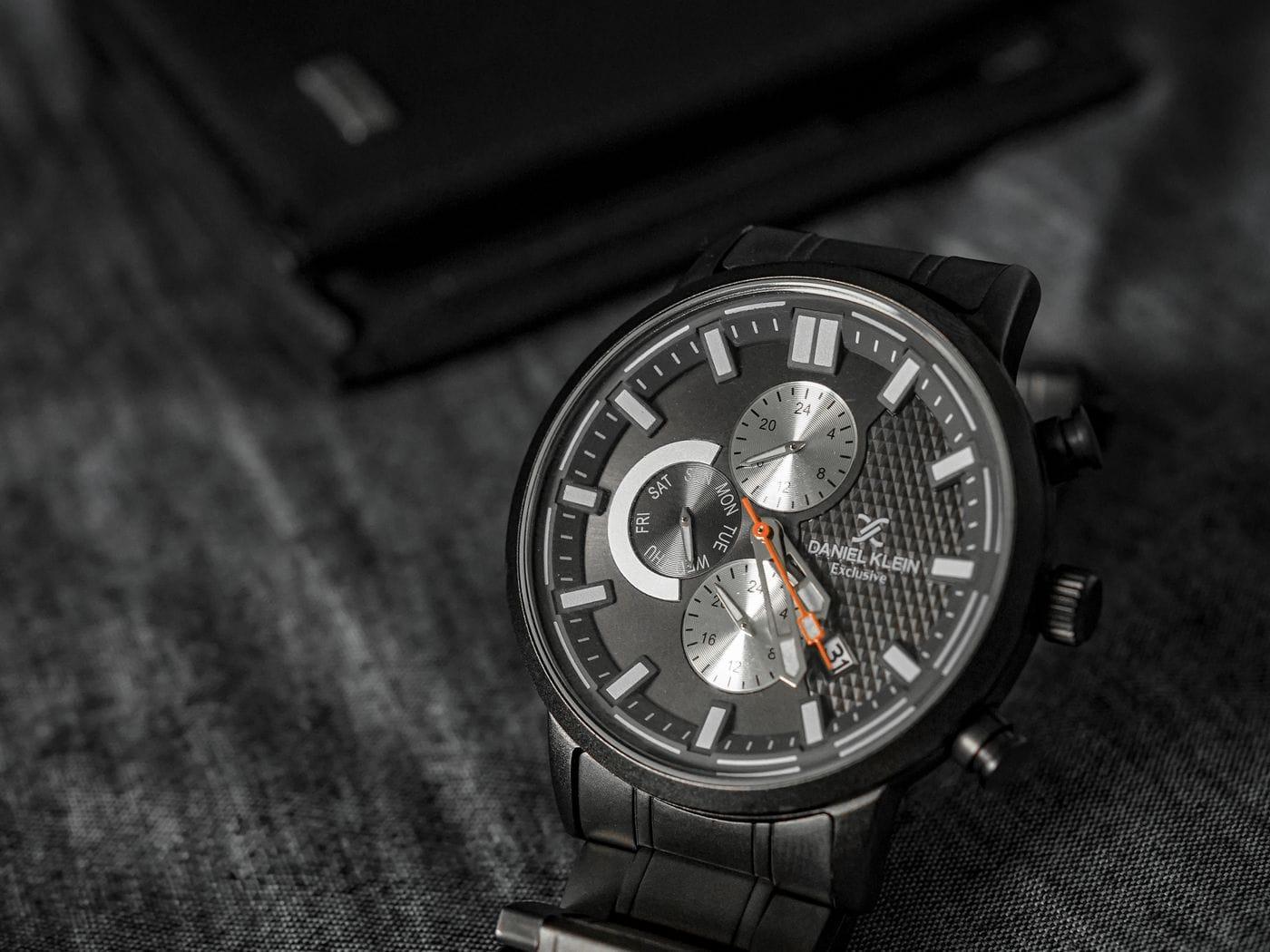 A wristwatch resting dial-up on a soft cloth, seen up close.